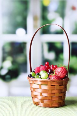 hasır sepet, parlak zemin üzerine ahşap masa üzerinde orman meyveleri