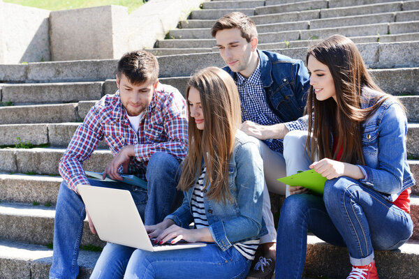 Students sitting on stairs in park