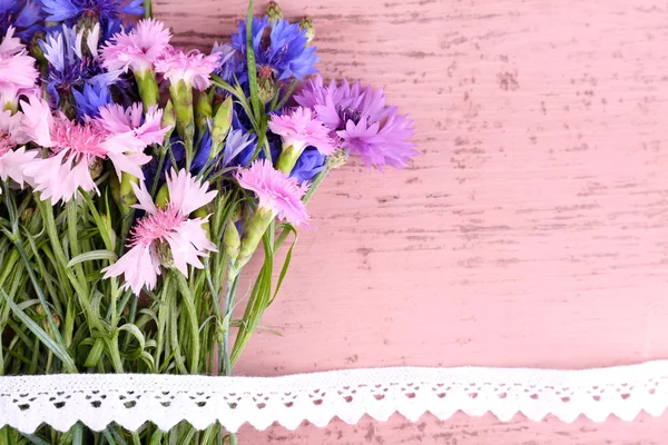 Beautiful bouquet with lace ribbon on wooden background — Stock Photo, Image