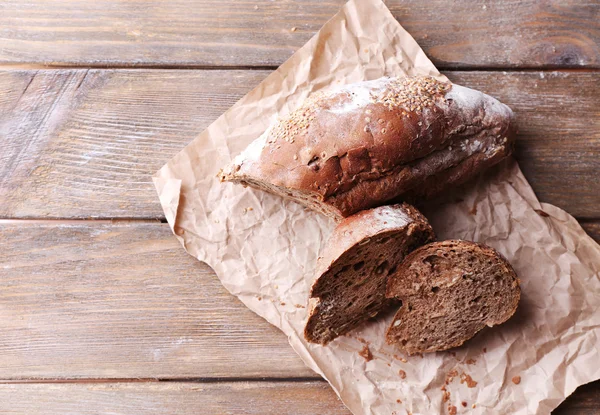 Fresh bread on wooden background — Stock Photo, Image