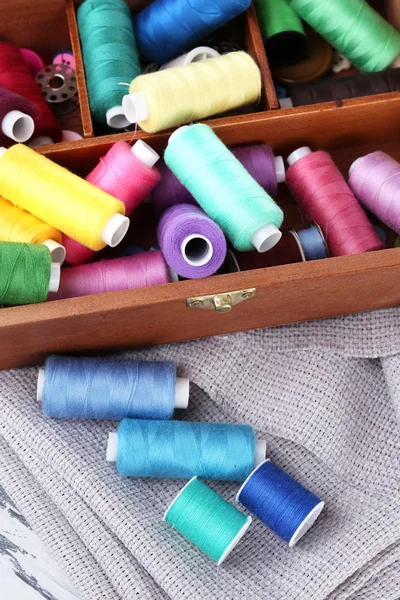 Colorful threads for needlework in wooden box close up — Stock Photo, Image