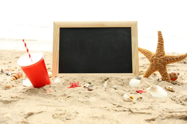 Blank chalkboard on beach background — Stock Photo, Image