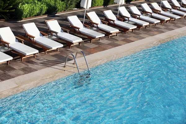 Lounge espreguiçadeiras perto da piscina — Fotografia de Stock