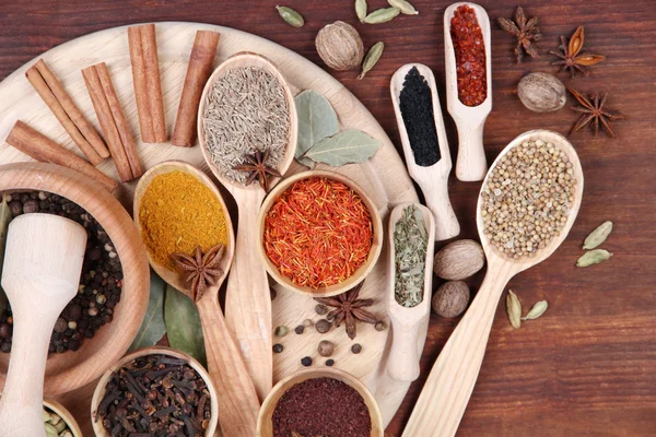 Various spices and herbs on wooden table — Stock Photo, Image