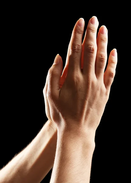 Menschliche Hände auf schwarzem Hintergrund — Stockfoto