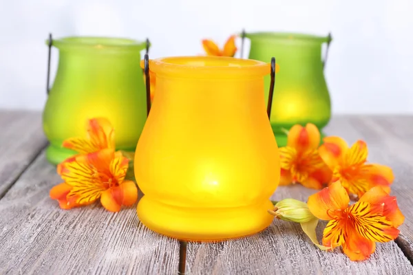 Bright icon-lamps with flowers on table on bright background — Stock Photo, Image