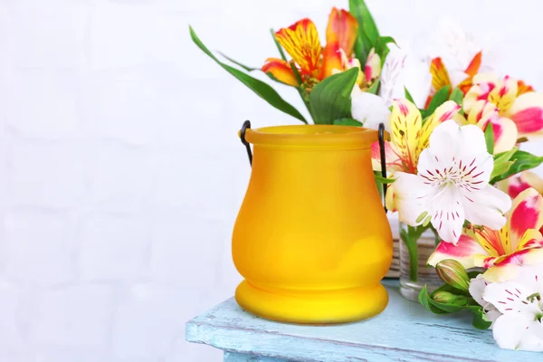 Bright icon-lamp with flowers on wooden stand on light background — Stock Photo, Image