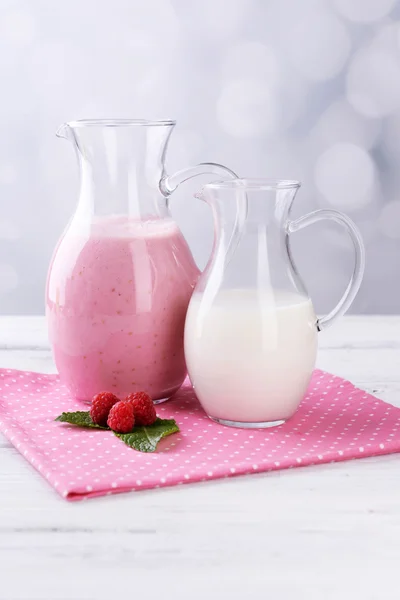 Glass jug of milk cocktail with raspberry — Stock Photo, Image