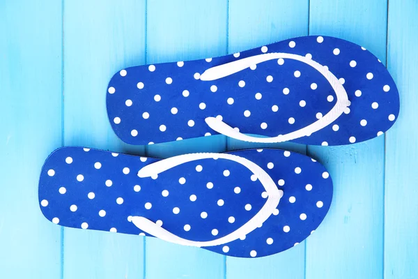 Color flip-flops on wooden background — Stock Photo, Image