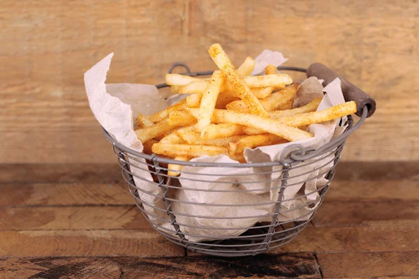 Tasty french fries in metal basket — Stock Photo, Image