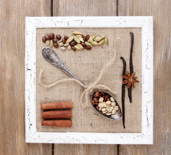 Wooden frame, vintage spoon and spices on wooden background — Stock Photo, Image