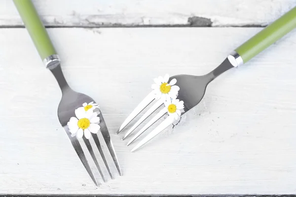 Forks with daisy flowers — Stock Photo, Image