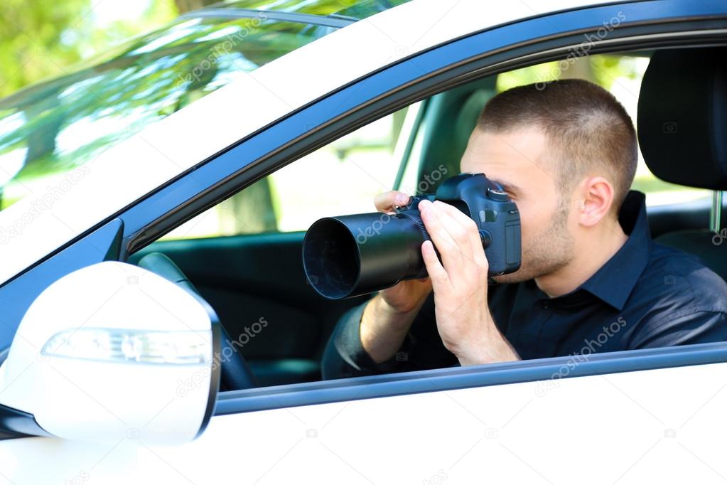 Man in car with photo camera