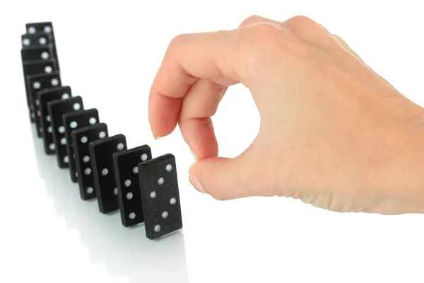 Hand pushing dominoes isolated on white — Stock Photo, Image