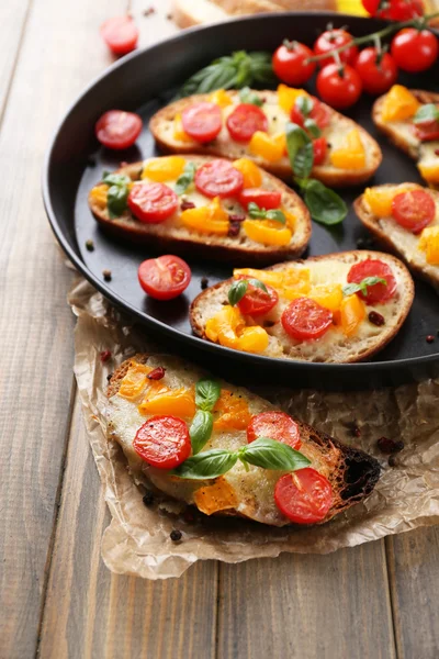 Tasty bruschetta with tomatoes — Stock Photo, Image