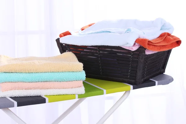 Basket with laundry and ironing board — Stock Photo, Image