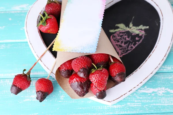 Strawberry in chocolate on skewers — Stock Photo, Image