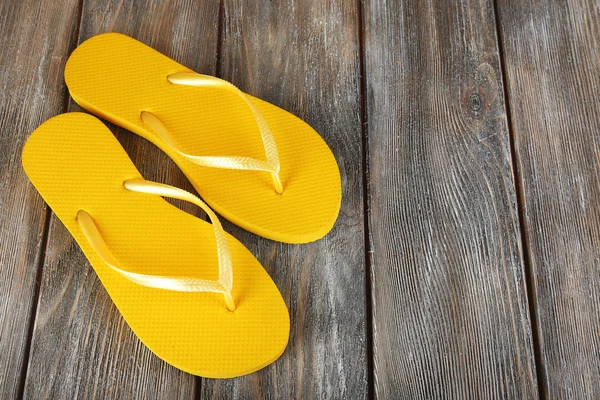 Colorful flip-flops on wooden background — Stock Photo, Image