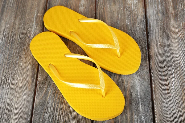 Colorful flip-flops on wooden background — Stock Photo, Image