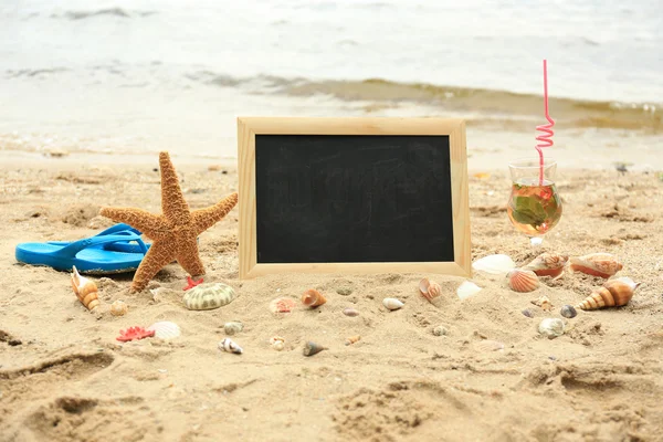 Blank chalkboard on beach background — Stock Photo, Image