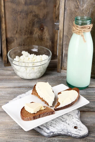 Dairy products: milk, butter, cottage cheese on wooden background — Stock Photo, Image