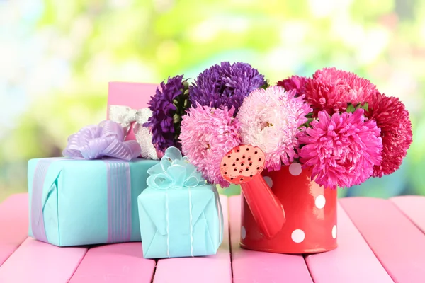 Presenter och blommor i kan — Stockfoto