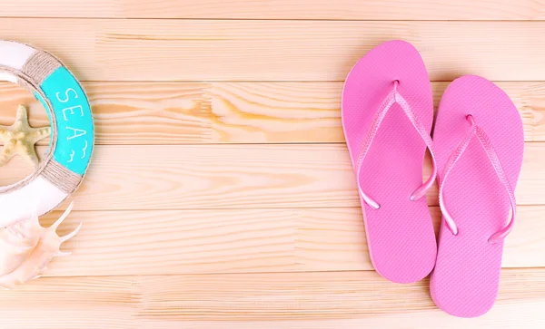 Bright flip-flops on wooden background — Stock Photo, Image