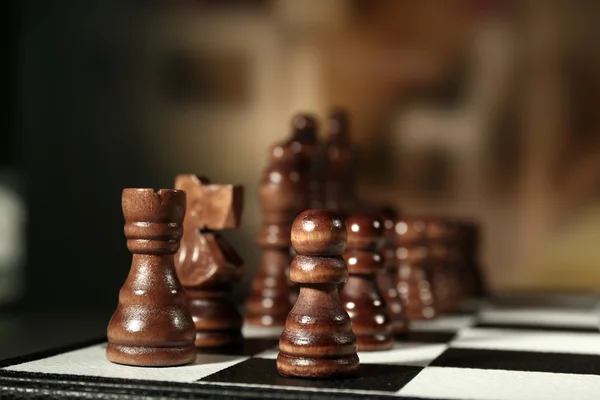 Chess board with chess pieces on brown background — Stock Photo, Image