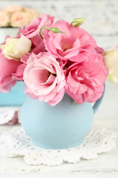 Bouquet of eustoma flowers in vase on wooden background — Stock Photo, Image