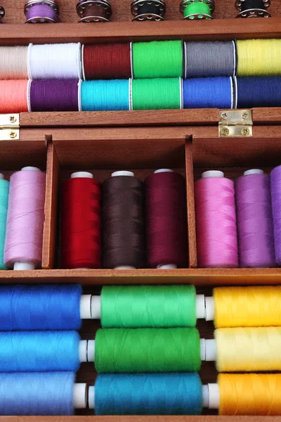 Colorful threads for needlework in wooden box close up — Stock Photo, Image