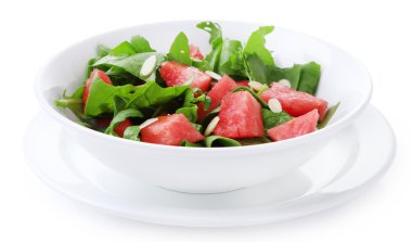 Salad with watermelon, onion, arugula and spinach leaves on plate, isolated on white clipart