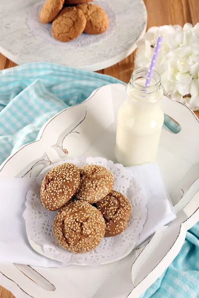 Milk and cookies on tray on table — Stock Photo, Image