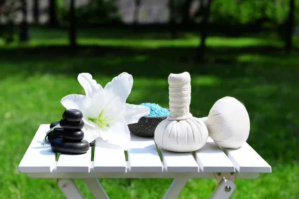 Herbal remedies for massage on table, outdoor — Stock Photo, Image