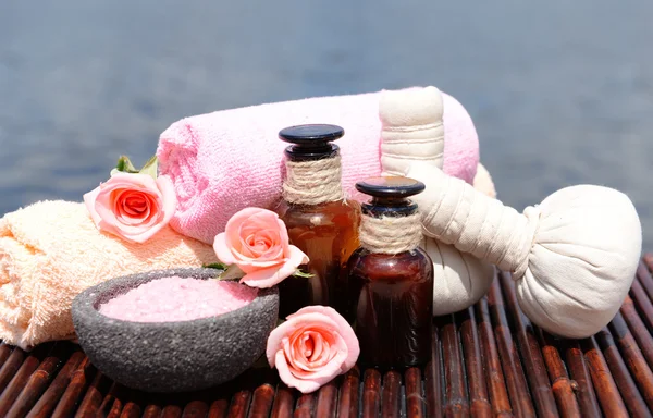 Herbal remedies for massage on bamboo mat, outdoor — Stock Photo, Image