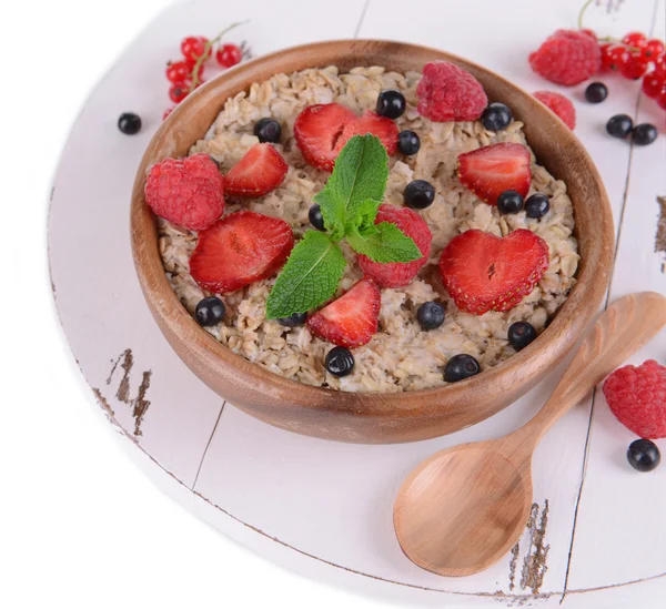 Tasty oatmeal with berries isolated on white — Stock Photo, Image
