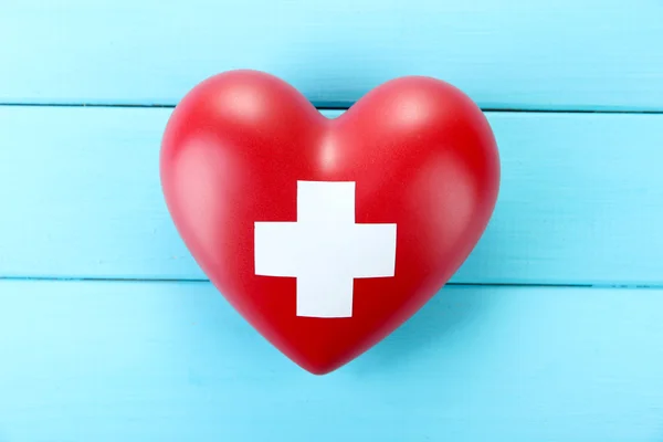 Red heart with cross sign — Stock Photo, Image