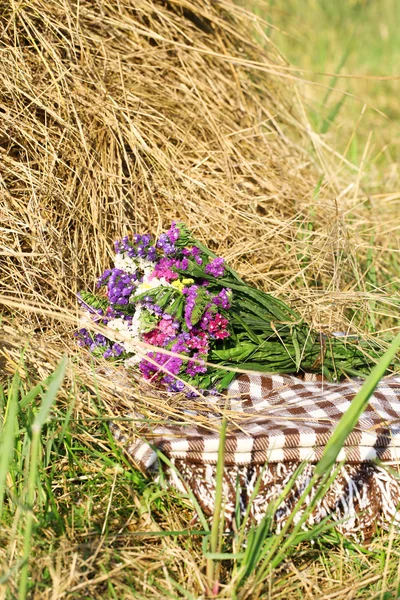 Beautiful wild flowers in bouquet in field — Stock Photo, Image