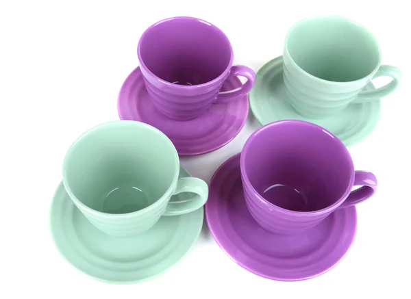 Bright cups and saucers isolated on white — Stock Photo, Image