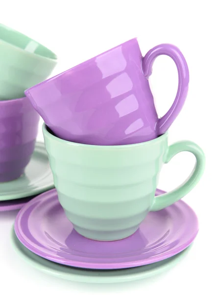 Bright cups and saucers isolated on white — Stock Photo, Image