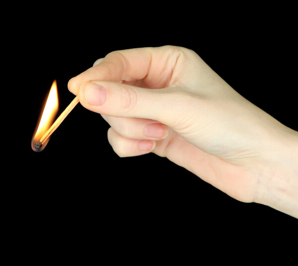 Burning match in female hand