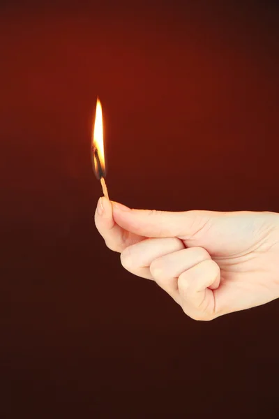 Burning match in female hand — Stock Photo, Image