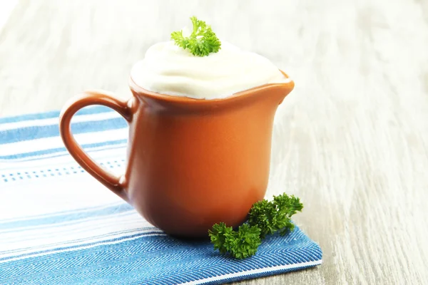 Sour cream in pitcher on table close-up — Stock Photo, Image