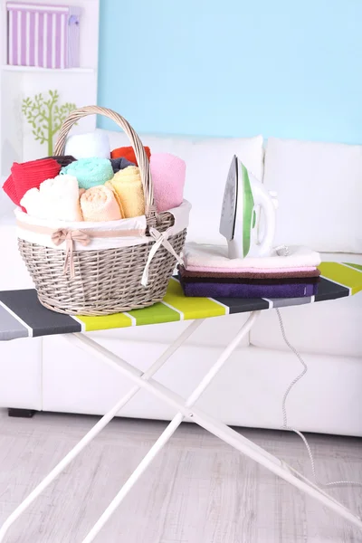 Baskets with laundry and ironing board — Stock Photo, Image