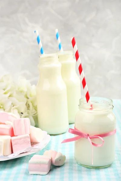 Milk in bottles with straws — Stock Photo, Image