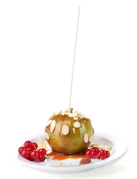 Sweet caramel apple on stick with berries, isolated on white — Stock Photo, Image