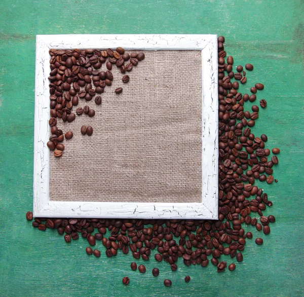 Wooden frame and coffee grains — Stock Photo, Image