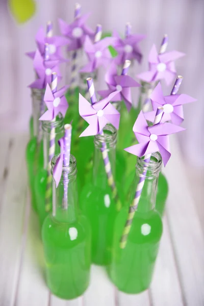 Bottles of drink with straw — Stock Photo, Image