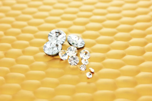 Diamonds on bright yellow background, close-up — Stock Photo, Image