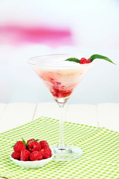 Raspberry milk dessert in cocktail glass, on light background — Stok Foto
