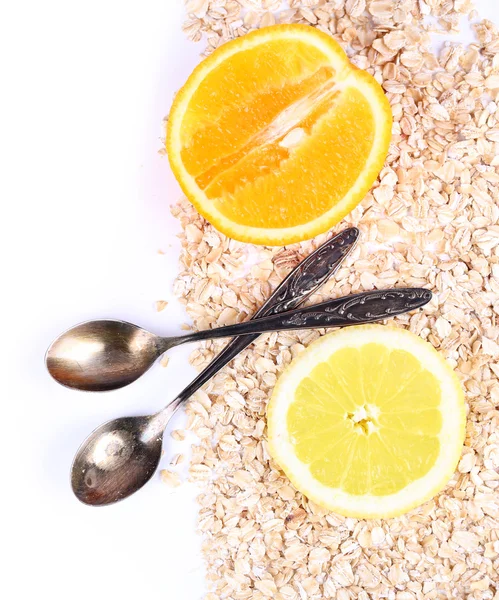 Lemon and orange slices with oatmeal and vintage spoons isolated on white — Stock Photo, Image
